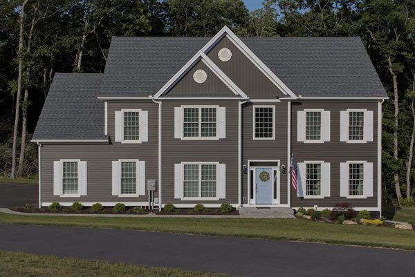 All American large basic grey home on a large plot of land